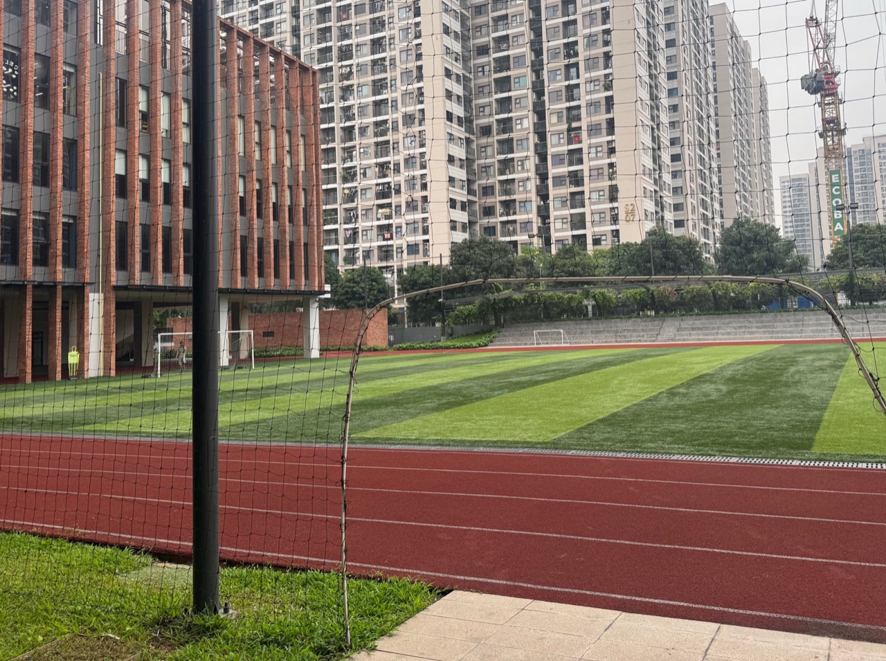 붉은 육상 트랙이 둘러싼 잔디 축구장